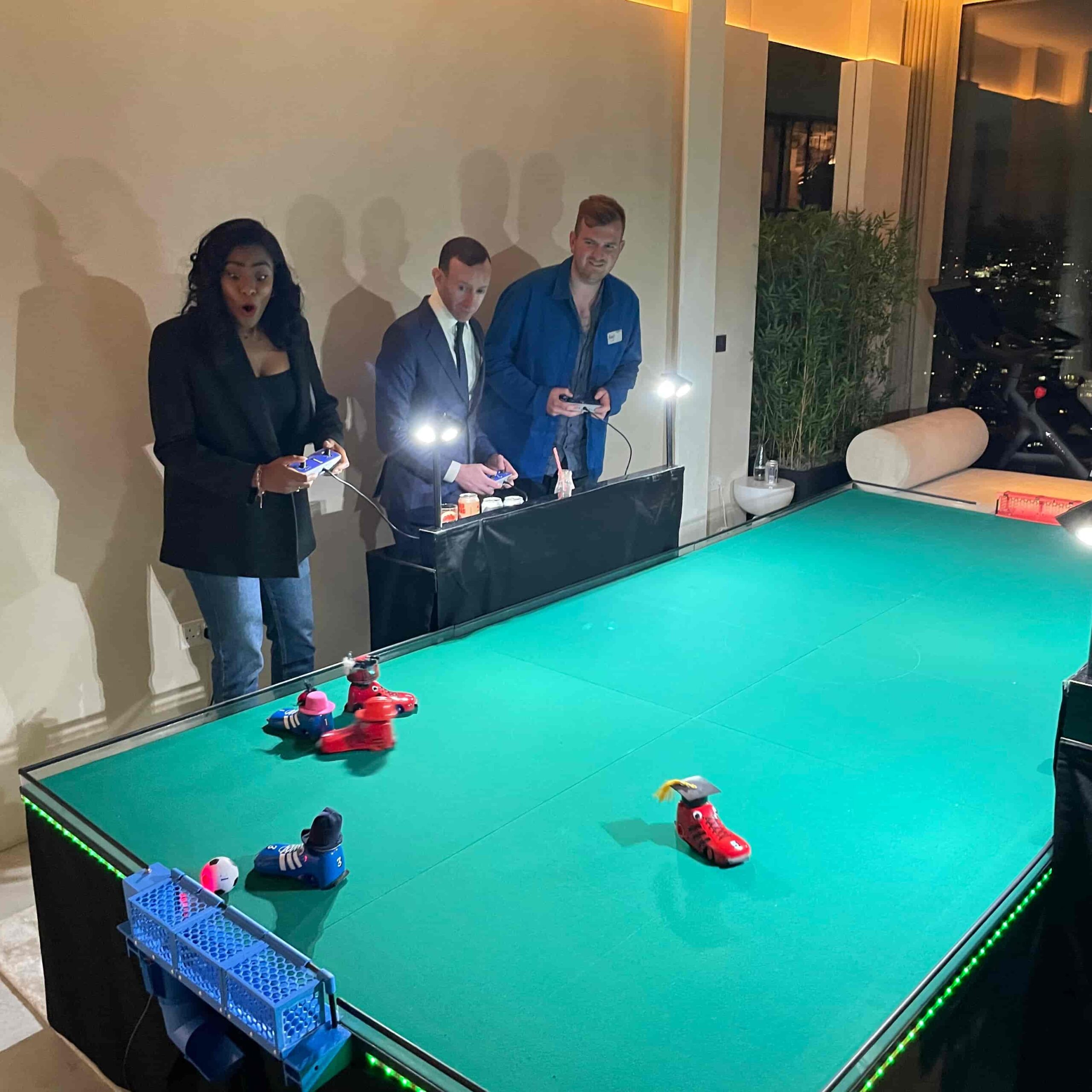 Guests playing a 6-player robot football game at an event, highlighting interactive entertainment hire for parties and corporate events.